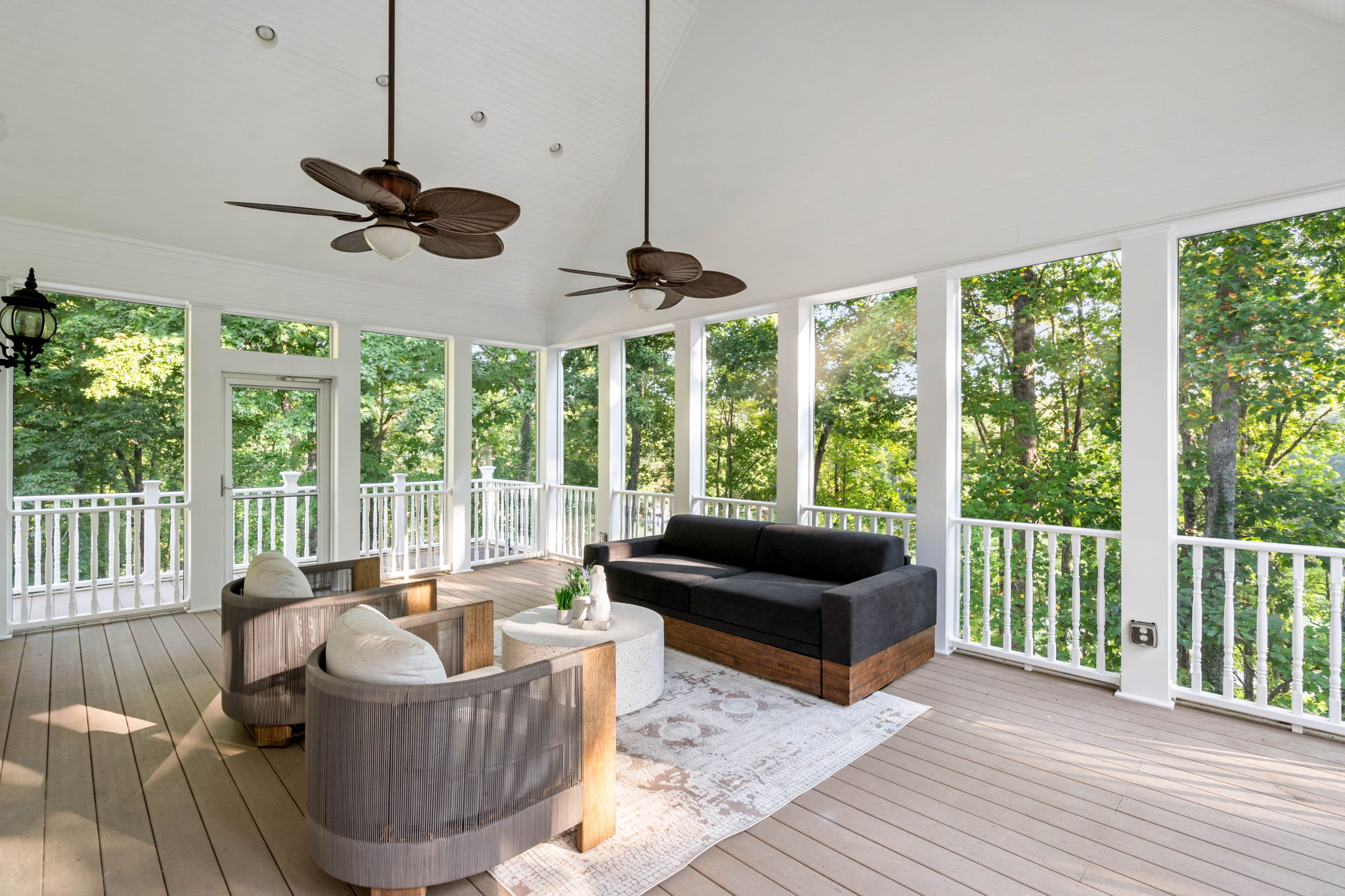 Beautifully finished screened porch with ceiling fans and lounge seating